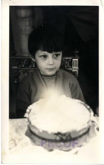 Photograph of Roland Joffe as a young boy with his birthday cake.